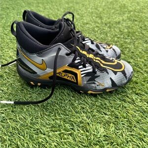 Nike Alpha Cleats in Black and gold